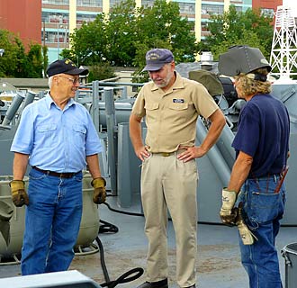 USS Slater Executive Director Tim Rizutto inspects the welding of the newly fabricated depth charge rack