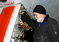 Frank Benson works on the C-97's Nose Gear